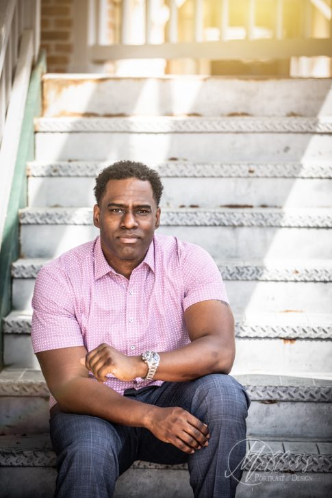 Head shots of black adult male on rusty staircase in northern Virginia with beautiful lighting.