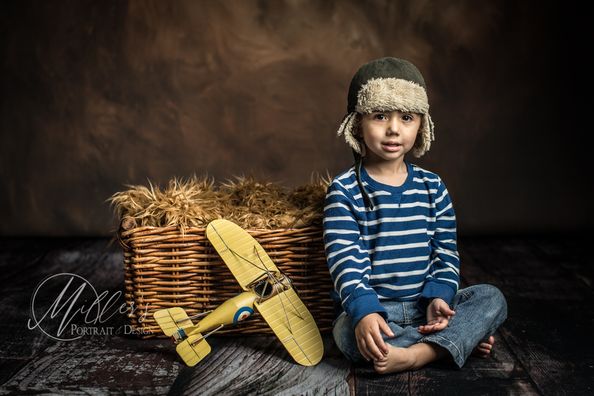 Two Year Portrait with Yellow Airplane and Wicker Basket
